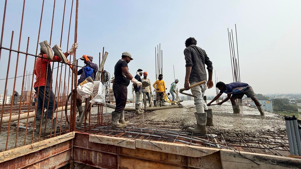 Crew placing and levelling freshly pumped concrete